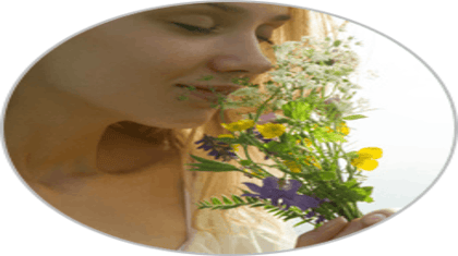 A girl holding flowers and sensing smell.