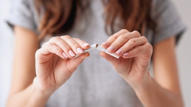 Image of woman breaking a cigarette