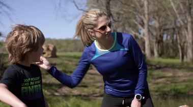 A woman and child in a field symbolize her journey to health after quitting smoking.