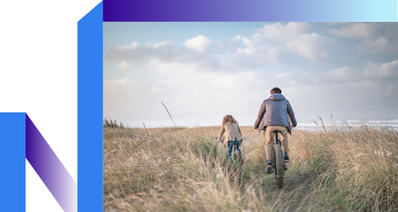 A man and young girl cycling in the fields