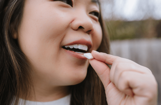 Woman popping gum. She isn't thinking about smoking.