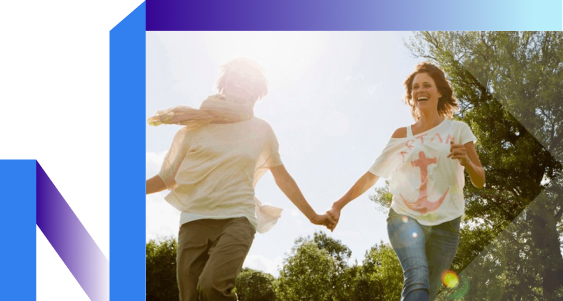 Two individuals joyfully holding hands while running together