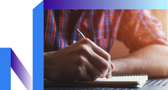 A person writing in a notebook, capturing thoughts with a pen.