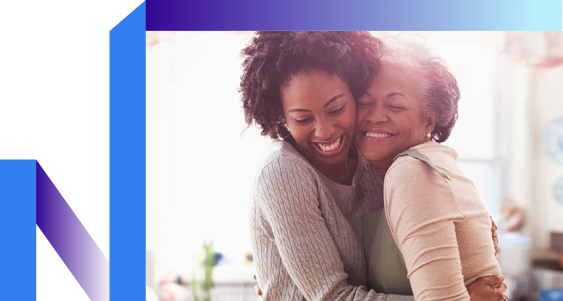Mother and daughter hug in front of a blue and purple background, expressing warmth and camaraderie