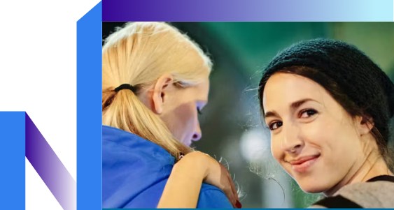 Two women share a joyful moment, hand in hand, highlighting their friendship.