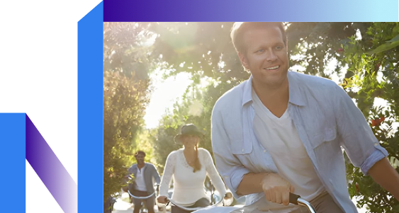 A couple cycling together on a sunny scenic path.