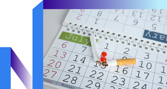 A broken cigarette with a red pawn on top lies on an open calendar displaying July. The image suggests a symbolic break from smoking.