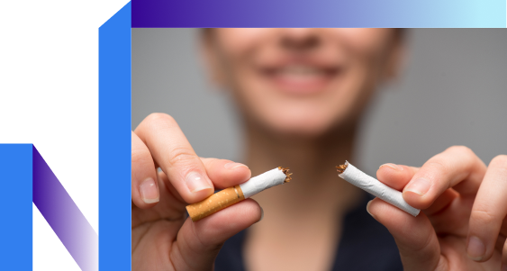 A person holds a broken cigarette in both hands, smiling in the background.