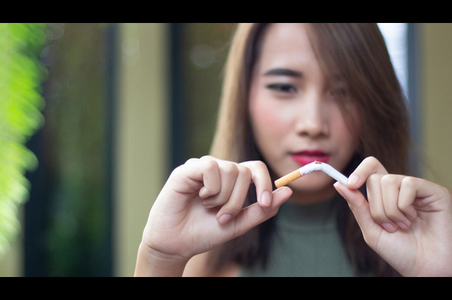 Girl breaking cigarette.