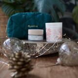Phytoceane pouch, Destination Ocean Wrinkle Smoothing Cream, and Phytoceane Summer Garden Candle sitting side by side.