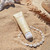 Moisturizing Body Lotion Destinatoin Bora Bora, 150 ml tube laying on the beach.
