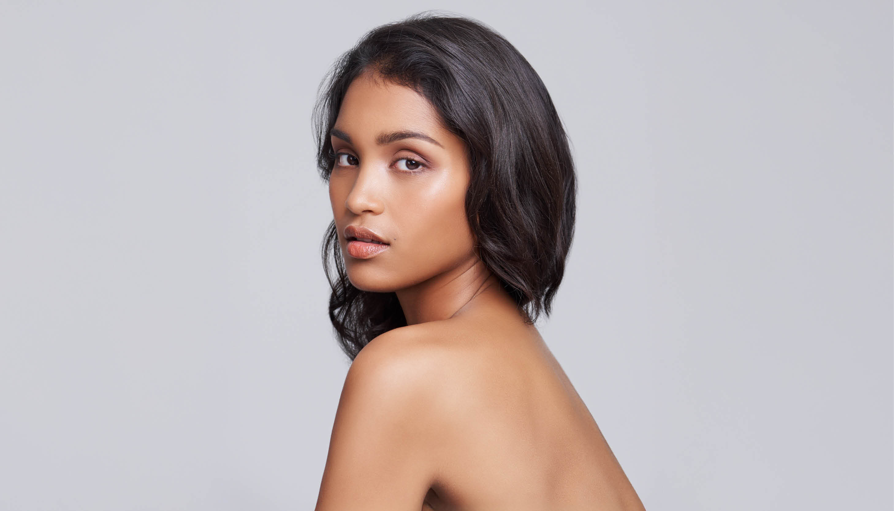 A woman with slicked back hair.