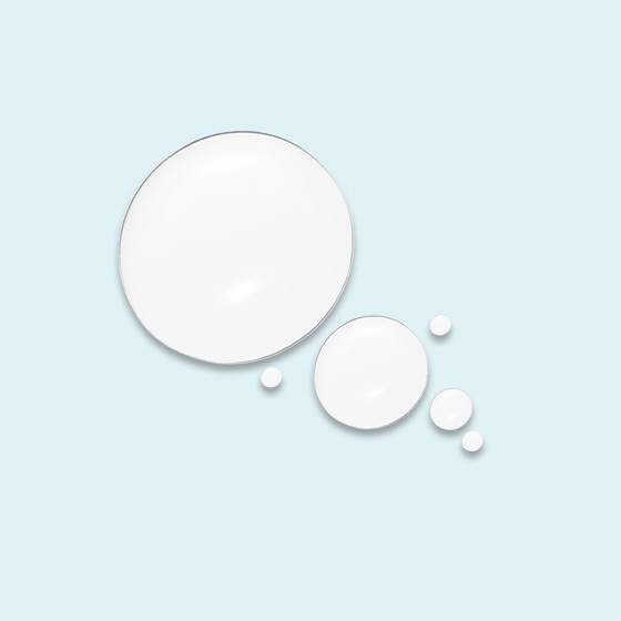 Clear water droplets of various sizes arranged on a light blue background.