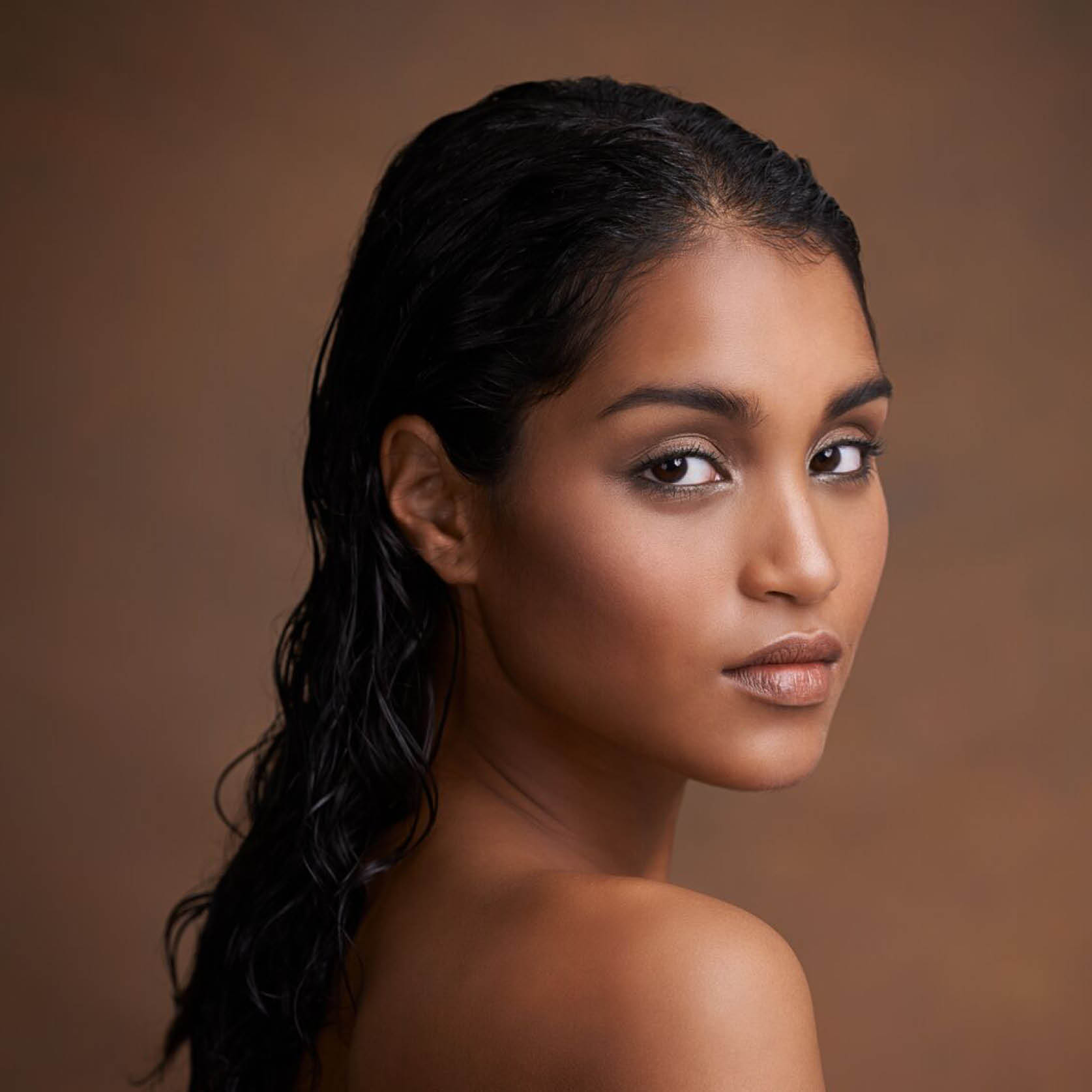 Indian woman looking over her shoulder.