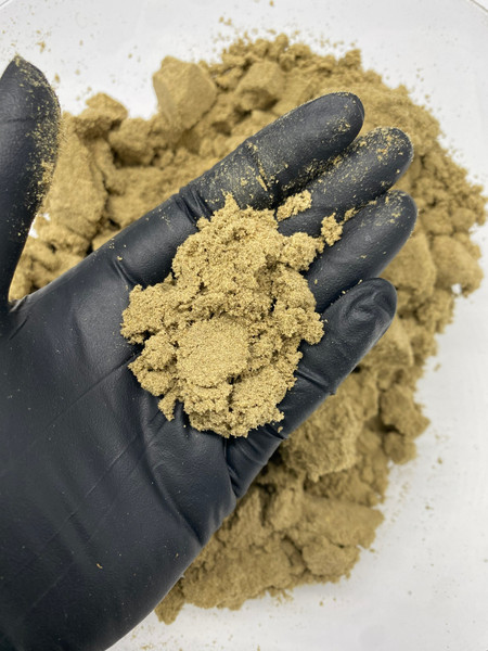 Loose THCa kief in bulk, shown as a golden-green pile of trichome-rich powder used for infused pre-rolls, blunts, and potency-boosted hemp products.
