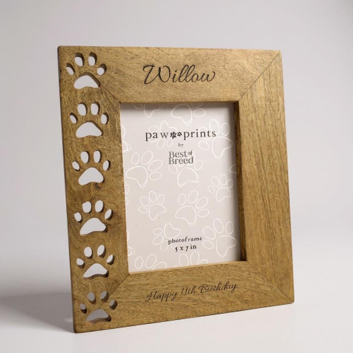 A handcrafted wooden picture frame with laser cut paw prints running down the right hand side. Made from mango wood. Customised with any text into the wood at top and bottom of the frame.