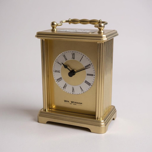 A gold plated carriage clock with easy to read roman numerials. Customised engraved message plate on top. Easy comfortable grip handle