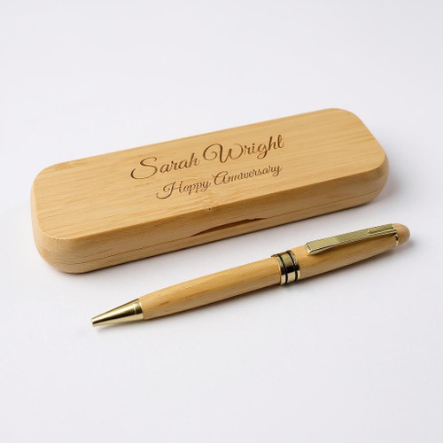 A wooden pen case and matching ballpoint case. Both items made from eco friendly bamboo. Pen has gold coloured pocket clip and parts. Customised text on case lid and pen .