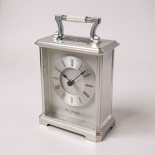 A silver plated carriage clock with easy to read roman numerals. Customised engraved message plate on top. Easy comfortable grip handle