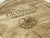 Close up of engraving of cheese and grapes engraved design.