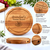 A round acacia wood cheese board with a 21 cm diameter and 3 cm thickness. The board features a circular routed groove and is engraved with the text "Grandad's Cheese Board" above a graphic illustration of cheese and grapes.