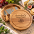 A round wooden cheese board with a swivel top, featuring the engraved text "Grandad's Cheese Board" and a engraved graphic of cheese. The board includes a hidden compartment containing four stainless steel cheese servers with wooden handles.