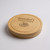 A wooden circular charcuterie board. Made from rubberwood with sliding opening lid to reveal 3 cheese servers. Customised text on top of lid with engraved stunning cheese and grapes design.