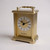 A gold plated carriage clock with easy to read roman numerials. Customised engraved message plate on top. Easy comfortable grip handle