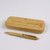 A wooden pen case and matching ballpoint case. Both items made from eco friendly bamboo. Pen has gold coloured pocket clip and parts. Customised text on case lid and pen .