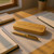 A wooden pen case and matching ballpoint case. Both items made from eco friendly bamboo. Pen has gold coloured pocket clip and parts. Customised text on case lid and pen .