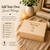 A rectangular light-coloured wooden storage box with a hinged lid. The lid is engraved with the text Happy 1st Father's Day, Daddy, Love Iziah xx, and 2026. The box features visible finger joint construction on the corners and a smooth finish.