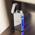 lifestyle image of slim ARC USb rechargable lighter with Liam engraved on the polished reflective front. Displayed with lid open on a wooden desk.