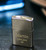 Close-up of personalised brushed chrome Zippo lighter engraved front