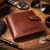 Personalised tan leather Visconti bi‑fold wallet with engraved name on front