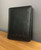 “Close-up of custom engraved initials / name on black RFID leather wallet