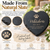 A heart-shaped black slate memorial plaque featuring laser-engraved text that reads Whiskers, 2001-2013, and YOU LEFT A PAW PRINT ON OUR HEARTS, accompanied by a paw print icon. The plaque has natural, rough edges and a textured surface.