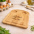 Personalised wooden dippy egg board with customised message on display on modern kitchen worktop