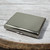 A rectangular, polished silver-tone metal cigarette case featuring a smooth, reflective surface with the engraved letters S.E.A. centred on the top lid. The case has a secure latch mechanism on the front edge and rounded corners.