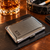 A rectangular silver-toned metal cigarette case with a textured crosshatch finish on the lid. The case features a smooth polished border and a small rectangular engraving plate on the lower left corner displaying the initials R.C.