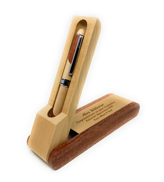 A two-toned wooden pen with a silver clip and centre band, resting in an open wooden case. The case features the engraved text: Alex Webster, Congratulations on your Graduation, Leicester University 2023, Love Mum & Dad.