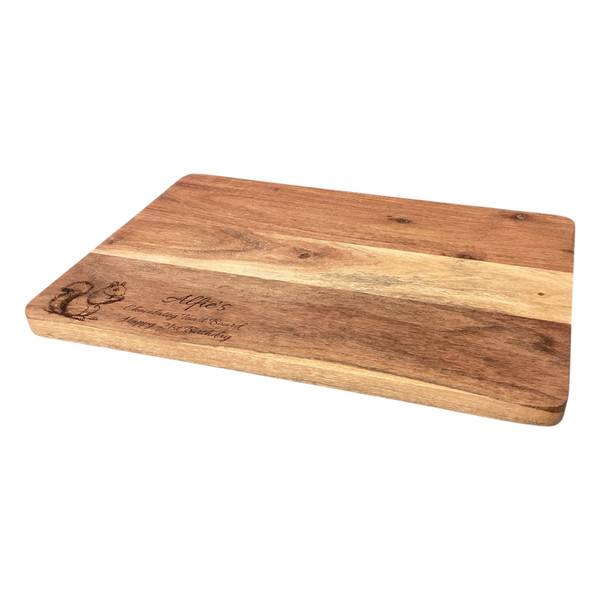 A 35cm wooden cheese board . Made from lovely 2 tone acacia wood. Laser engraved with a image of a squirrel on left corner and custom engraved with any message of your choosing.