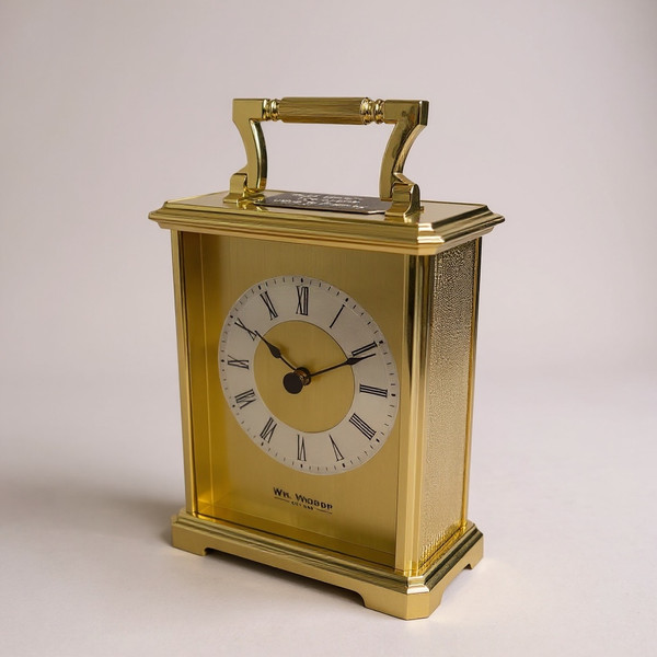 A gold plated carriage clock with easy to read roman numerals. Customised engraved message plate on top.