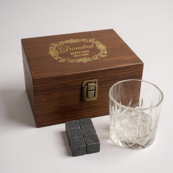 A whisky stones handmade rustic gift set. Wooden presentation box with clasp and customised text on lid. Supplied with glass tumbler and whisky cooling stones