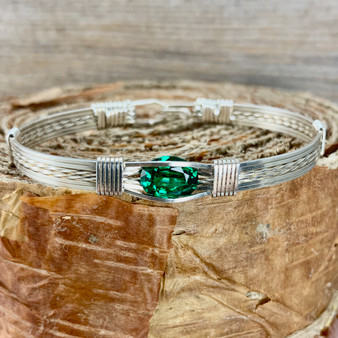 May's birthstone is a striking bright crisp green color. This Synthetic Emerald Wire Wrap Bracelet is shown in Argentium Sterling Silver but available with 20 different metal combinations and 5 different bracelet band styles. We also custom size for whatever finished bracelet you need to fit properly. HAVE IT YOUR WAY. 