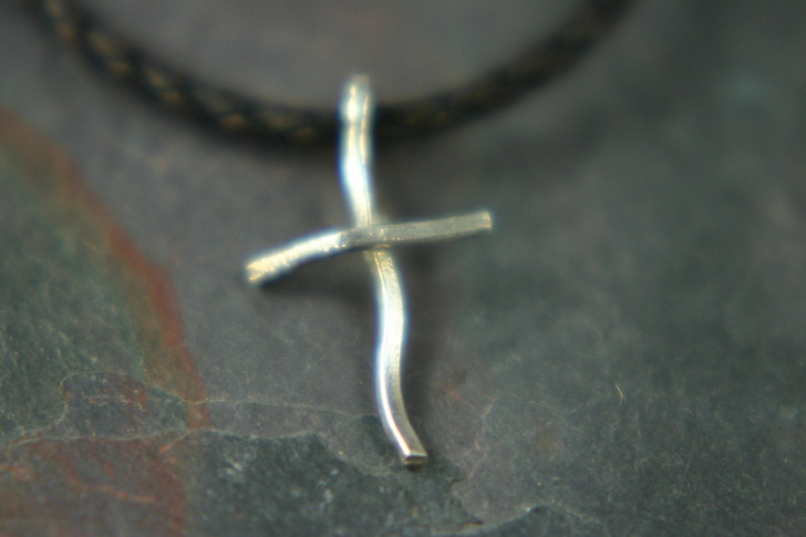 Shown is a sterling silver Crooked Cross. We also offer this simple cross in solid 14 Kt. Please call for pricing and availability.