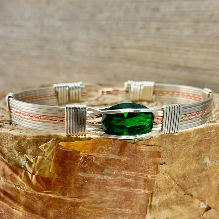 Shown is an all Argentium Silver and Rose Gold classic band bracelet paired up with a synthetic Emerald, May's birthstone. Choose this or any number of other gemstones to create your next heirloom treasure from the Kimberley Jade - Wired Out Of Hand Collection. Handmade in USA. 