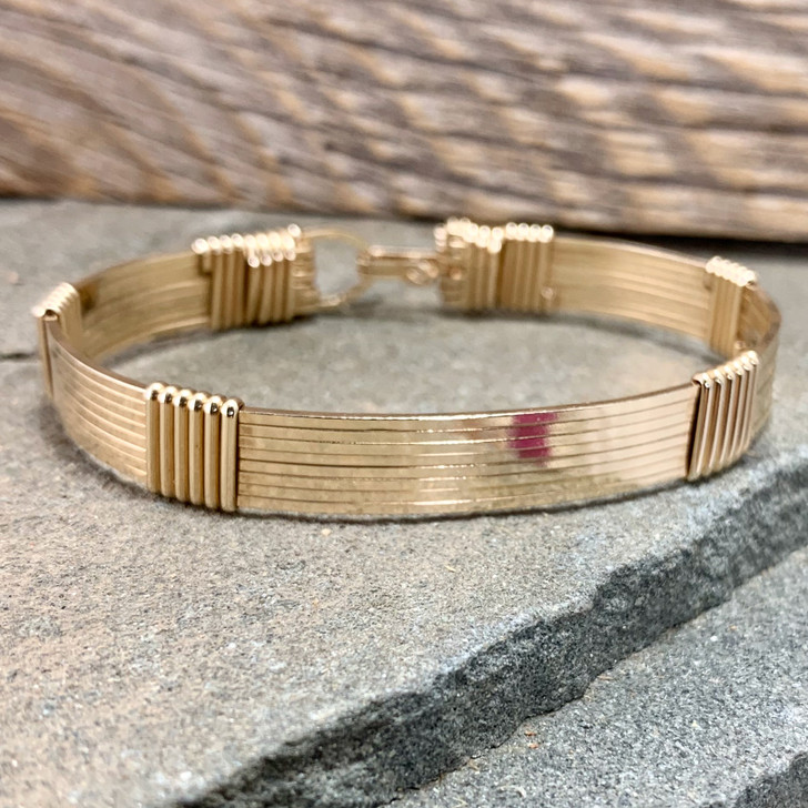 All Yellow Gold 8 wire bracelet shown in a Minimalist Style Band. This gold is an "Old English Rolled Gold" which is a layer of 14 Kt bonded to a center core of brass. Looks and feels like a solid 14 Kt bracelet but is more durable and less expensive. Satisfaction Guaranteed. 