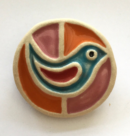Bird brooch made from a white stoneware clay and coloured glazes.
Supplied on a product card.