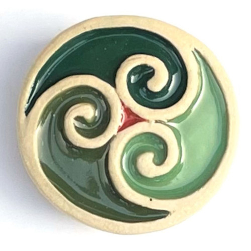 Tri-spiral brooch made from white stoneware clay and coloured glazes.