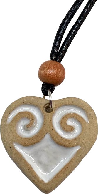 Handmade white stoneware heart pendant, decorated with red and white ceramic glaze.

The pendant is finished with a black waxed cord choker and wooden bead, with a lobster clasp and chain link adjustable from 18 to 21 inches. Heart Pendants are packaged against a branded presentation card. 

The pendant has a 35mm diameter with 4mm depth.